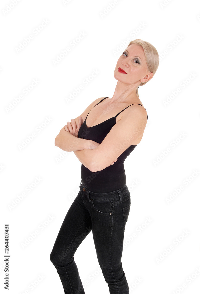 A serious looking blond woman standing in black outfit A serious looking blond woman standing in black outfit
