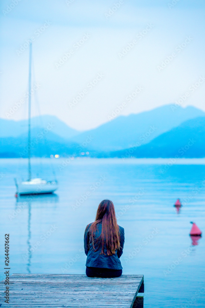 girl looks in the evening on the lake garda