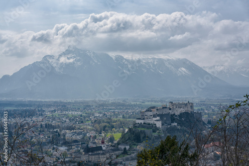 Stunning panorama of the Austrian city of Salzburg with clouds, houses and a mountain from a bird's eye view