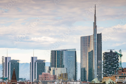 Famous skyscrapers in the business district of Milan  Italy  Europe. Mountains seen behind the city skyline.