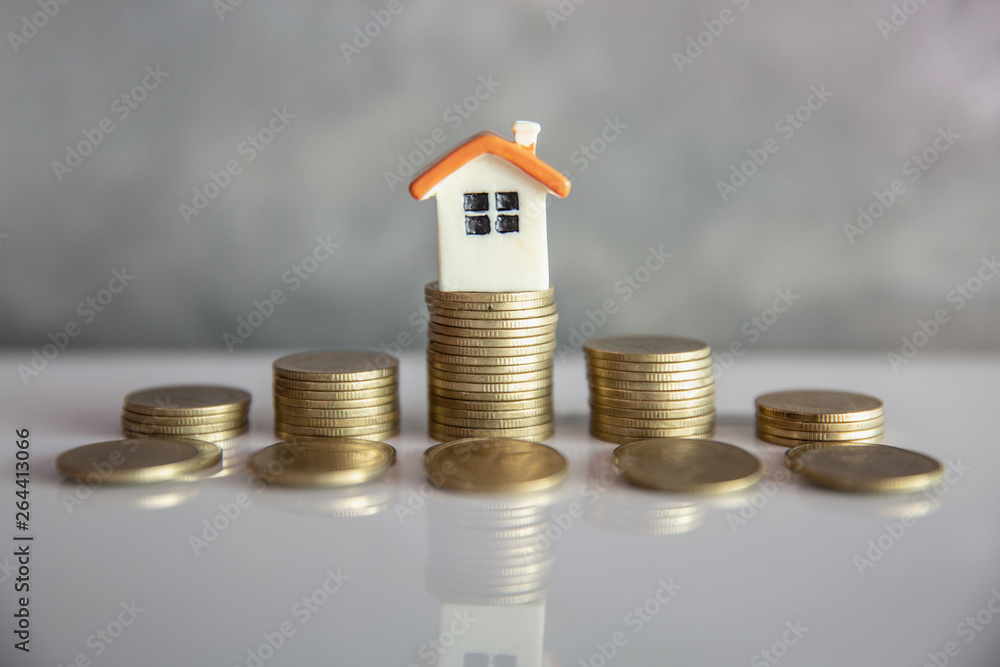 Mini house on stack of coins. Concept of Investment property and Risk Management. Mini house on stack of coins. Concept of Investment property and Risk Management.