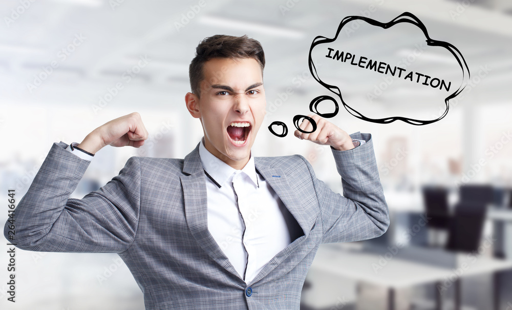 Business, technology, internet and networking concept. Young entrepreneur shouts out a keyword: Implementation Business, technology, internet and networking concept. Young entrepreneur shouts out a keyword: Implementation