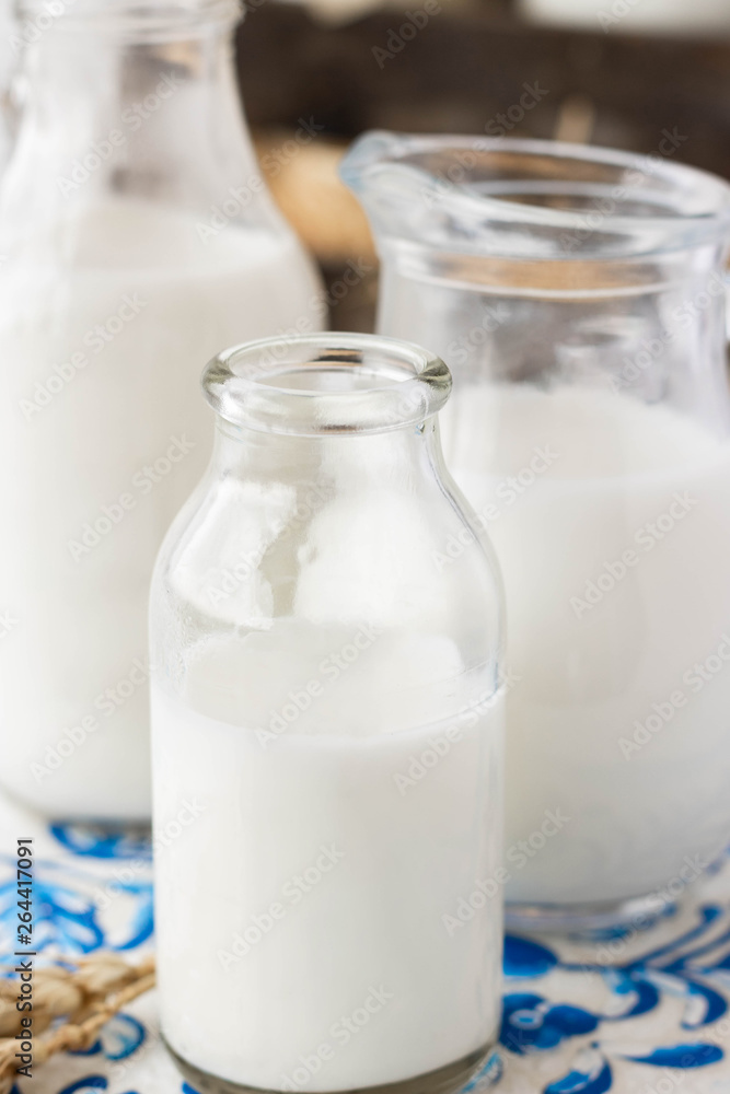 Milk in bottles of various shapes and sizes Milk in bottles of various shapes and sizes