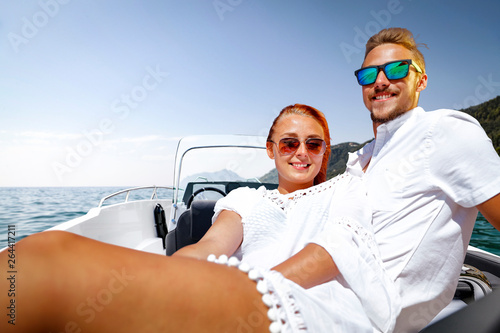Two young people on summer boat and ocean landscape 