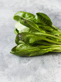 Some green romano lettuce on a  on grey background