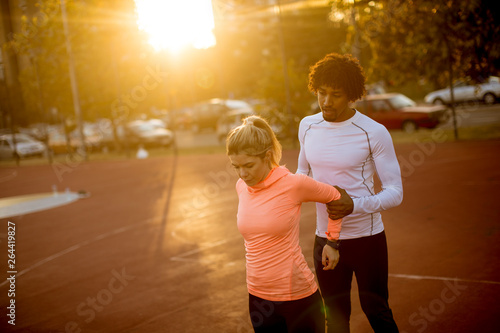 Personal trainer helping wo...