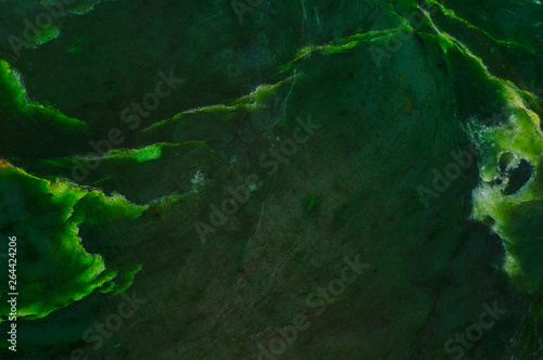 Abstract background. Surface of natural dark green jade photo