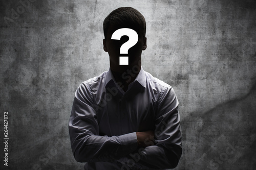 Anonymous man in a business shirt with question mark on his face on dark background