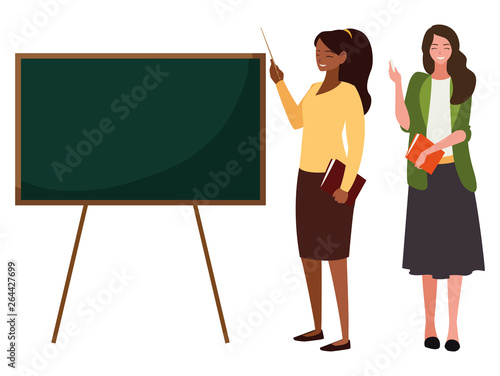interracial female teachers couple with textbooks and chalkboard
