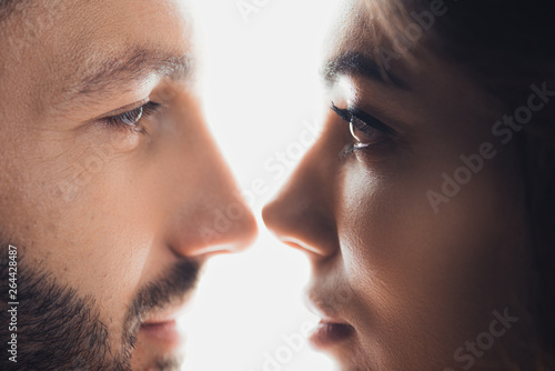 cropped view of loving couple looking at each other isolated on white