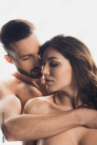 handsome bearded man embracing nude girlfriend isolated on white