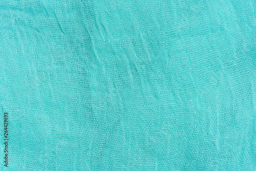 Texture of light blue fabric. Turquoise abstract background. Fabric navy blue close-up. photo