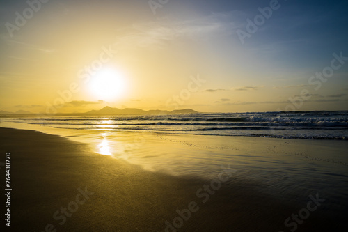 Spain, Lanzarote, Famous beautiful surfer paradise beach famara in magic orange sunset light