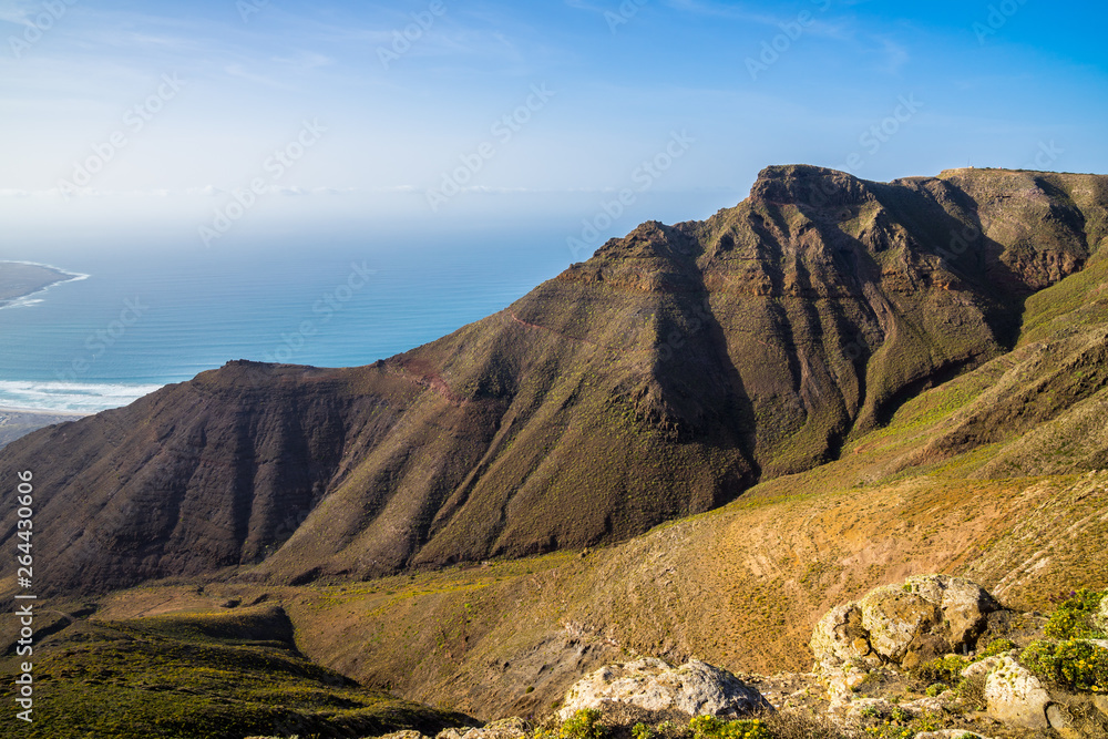 Spain, Lanzarote, Above green rocky mountains of famara massif from above