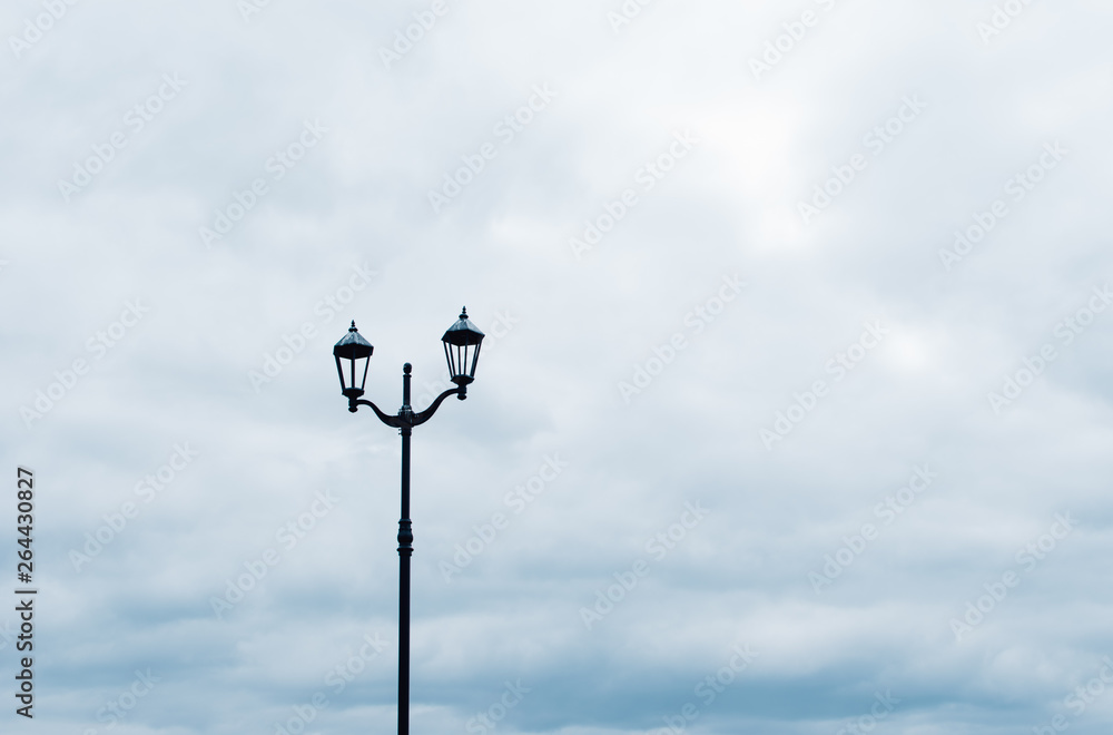 Street lamp against a cloudy sky.