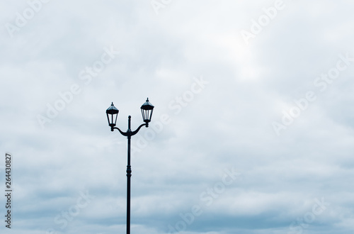 Street lamp against a cloudy sky.