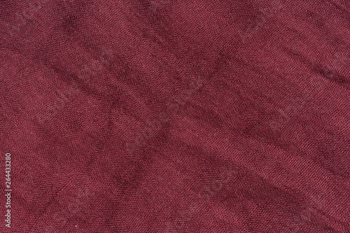 Texture of dark pink fabric. The texture of the fabric color Marsala. Burgundy scarf close-up. Female red stole.