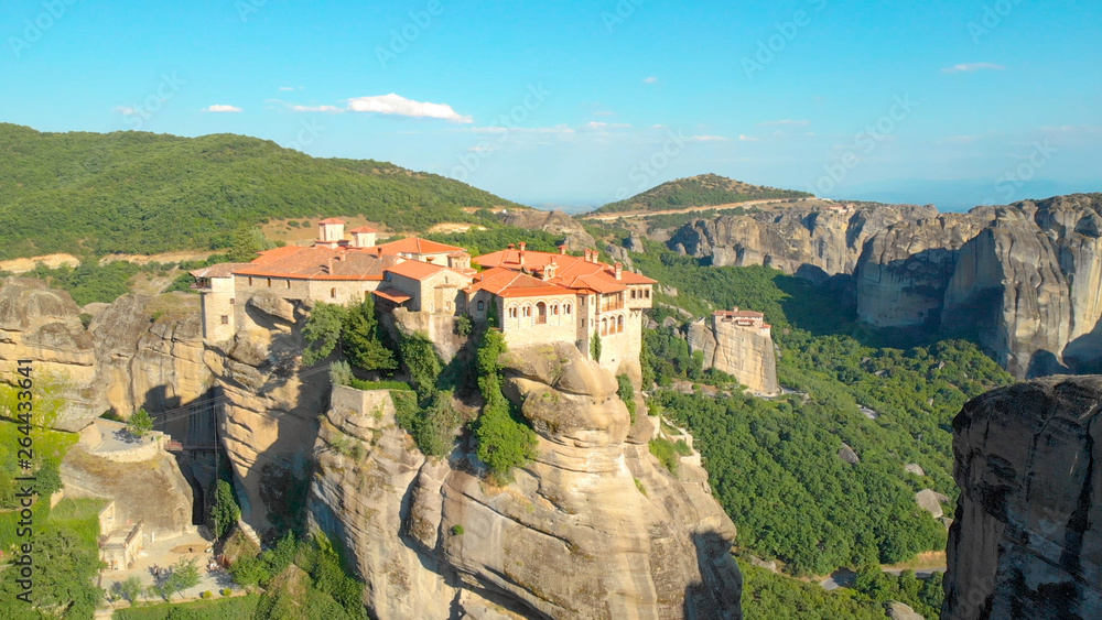 DRONE: Secluded monastery sits on top of a towering cliff in rural Greece.
