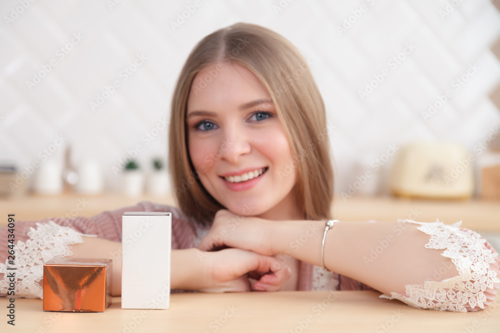Closeup portrait of beautiful young girl holding skincare cosmetics, box with face cream, serum. Place for text, copy space. Concept photo shoot luxury natural cosmetics shop Closeup portrait of beautiful young girl holding skincare cosmetics, box with face cream, serum. Place for text, copy space. Concept photo shoot luxury natural cosmetics shop