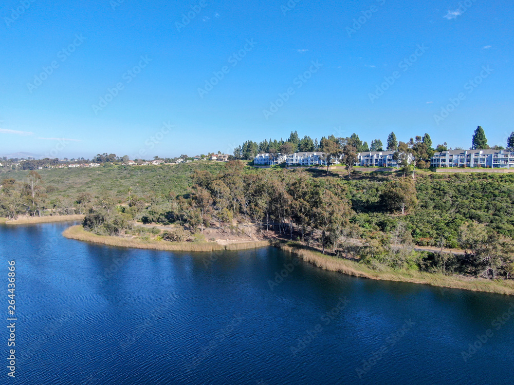 Fototapeta premium Aerial view of Miramar reservoir in the Scripps Miramar Ranch community, San Diego, California. Miramar lake, popular activities recreation site including boating, fishing, picnic & 5-mile-long trail.