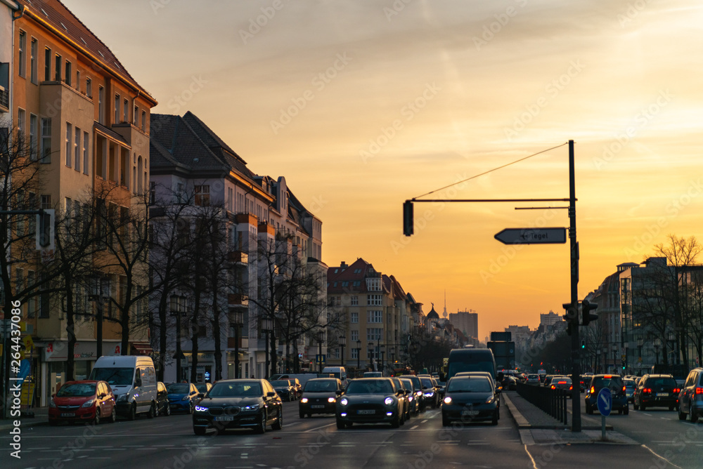 Morning in Berlin. City view of the road with cars. Road sign to Tegel airport.