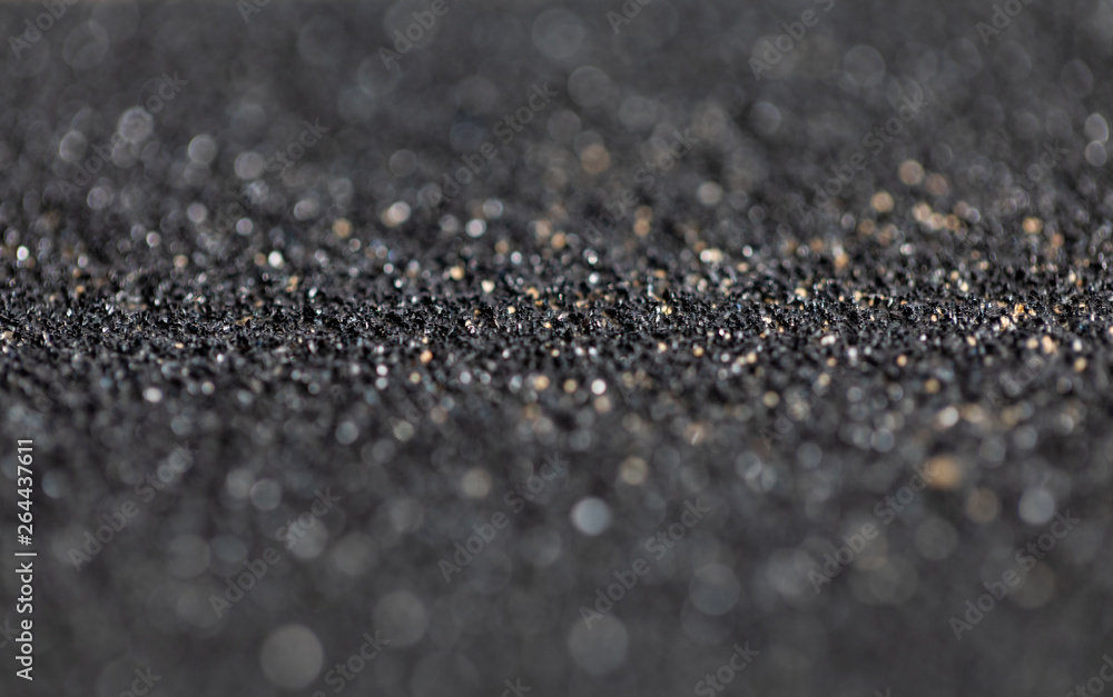 Sandpaper black bokeh light effect with soft background Sandpaper black bokeh light effect with soft background