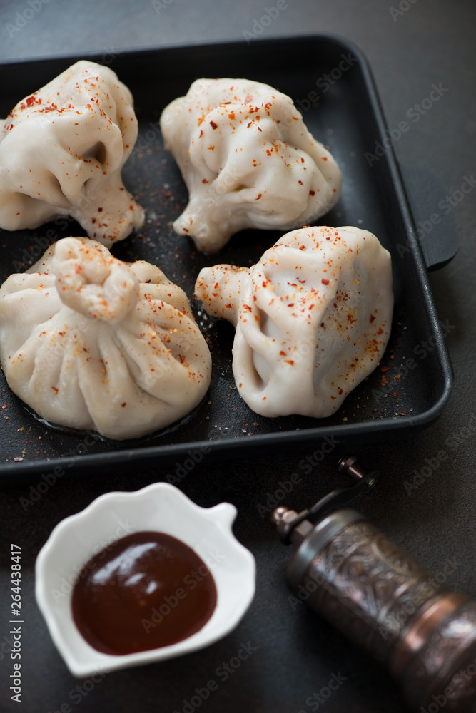 Close-up of khinkali or georgian dumplings with meat stuffing, vertical shot Close-up of khinkali or georgian dumplings with meat stuffing, vertical shot
