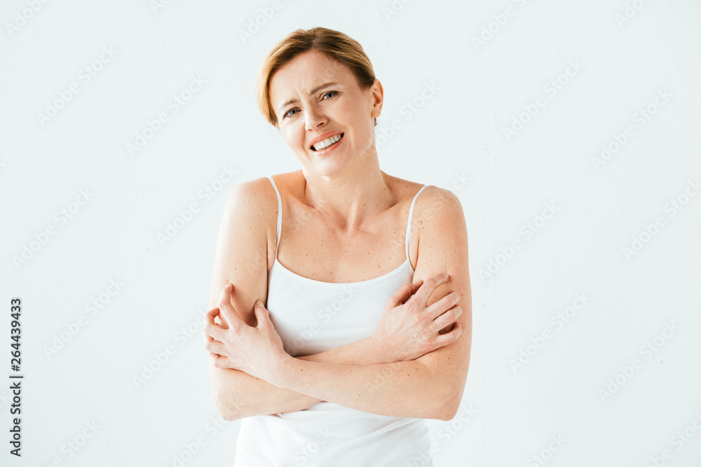 sick woman scratching skin while looking at camera isolated on white sick woman scratching skin while looking at camera isolated on white