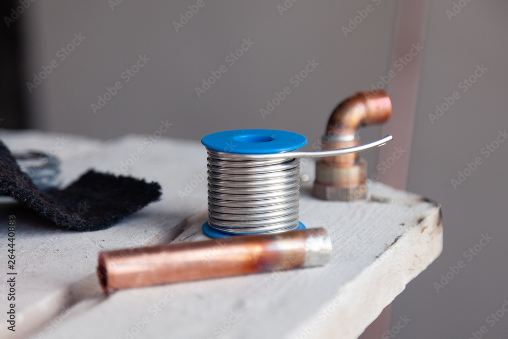 Closeup copper pipes, fittings, aluminum flux paste for solder for