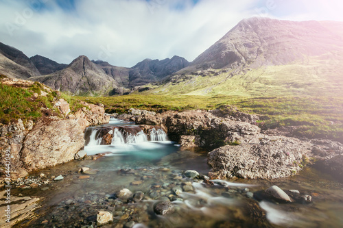 Beautiful waterfalls scenery on the Isle of Skye, Scotland: The Fairy Pools, Glen Brittle, Scotland. Sunshine.