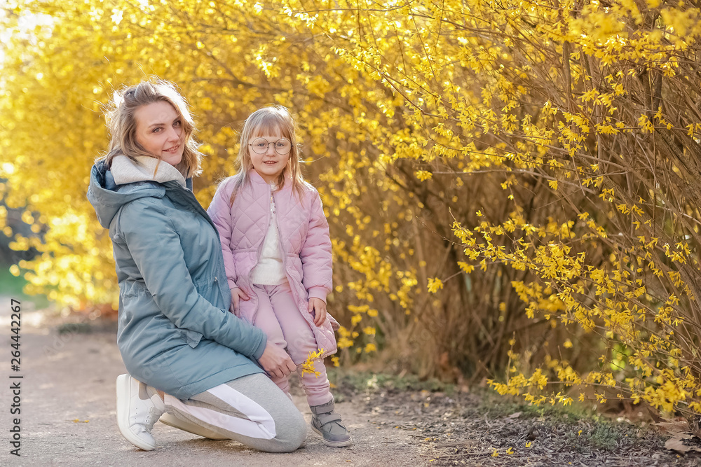 Fototapeta premium Mother and little daughter playing together in a park