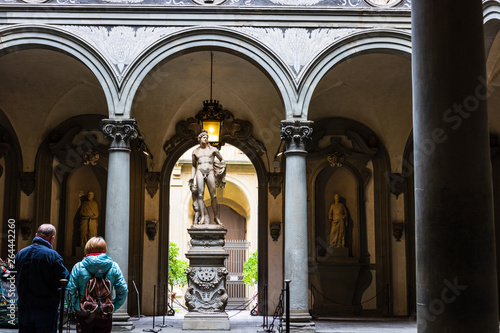 Tourists looking at David by Michelangelo in Galleria dell'Accademia in Florence. Italy photo