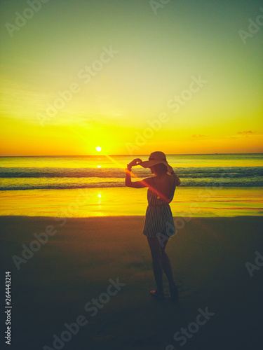 Girl enjoying at the ocean / sea view at sunset time.