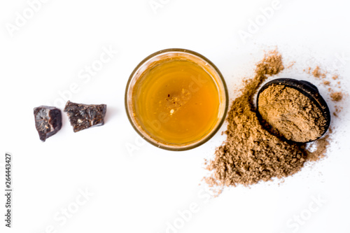 Home remedy to reduce headache or to treat headache isolated on white i.e. Hing or Devil's dung powder well mixed in water. photo