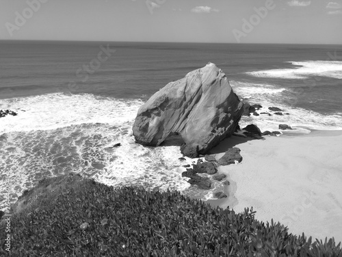 Bing Rock in a sandy beach. Portugal Santa Cruz