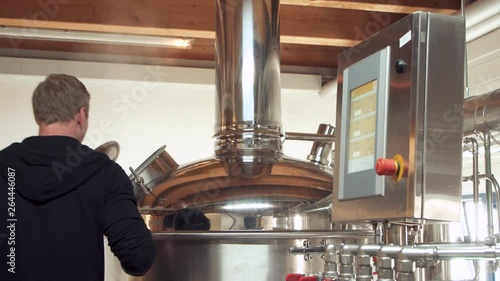 craft beer brewer setting up brewing kettle