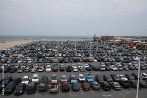 aerial view of a parking lot with the ocean on a background
