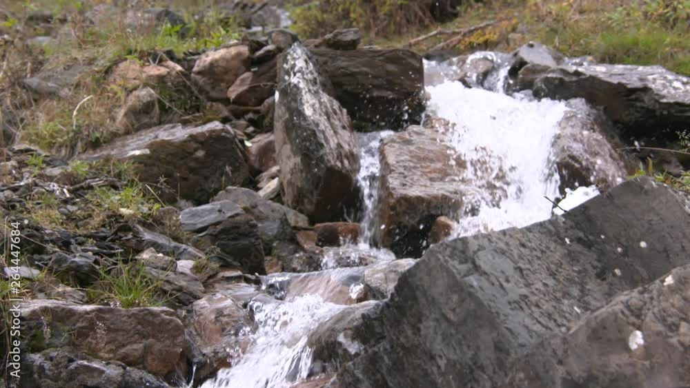 a man walking across a stream in alaska a man walking across a stream in alaska