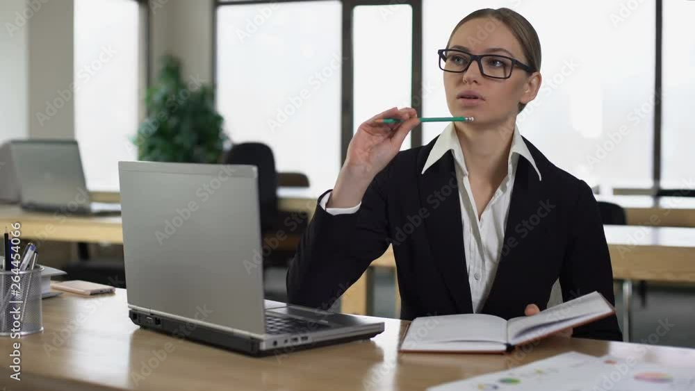 Woman thinking over startup, writing business ideas into notebook, task planner
