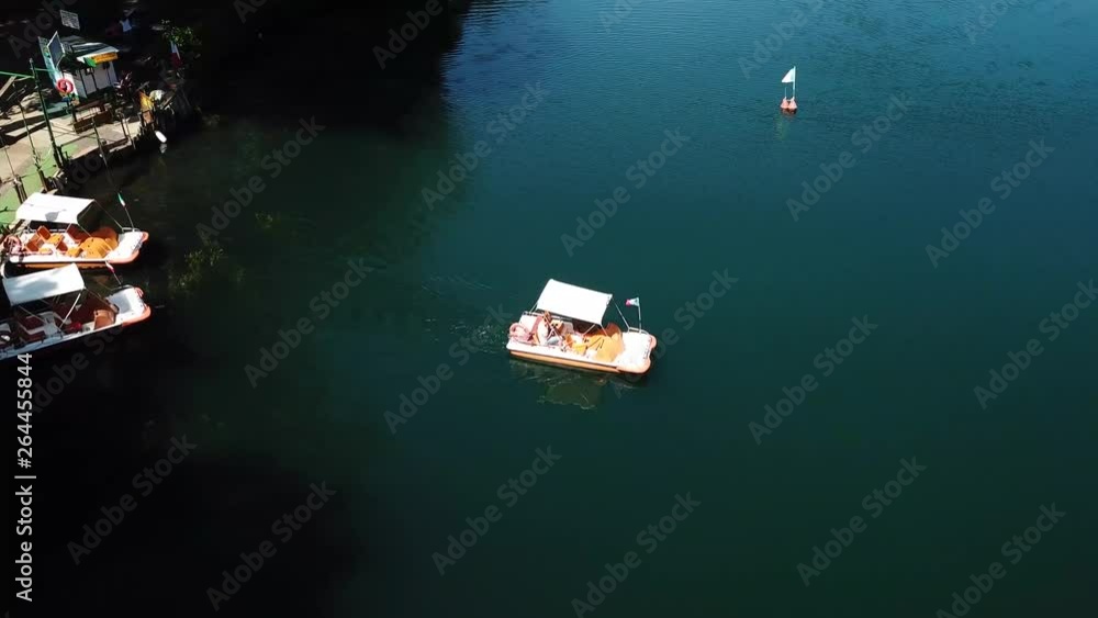 view of a small boat at Monticchio's lakes from a drone view of a small boat at Monticchio's lakes from a drone