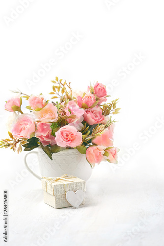 heart gift and pink flowers. Holiday, Weekend, Wedding, Valentine's day, Happy Mothers Day, birthday greeting card. heart and flowers on white background. Holiday spring season, festive design © Ju_see