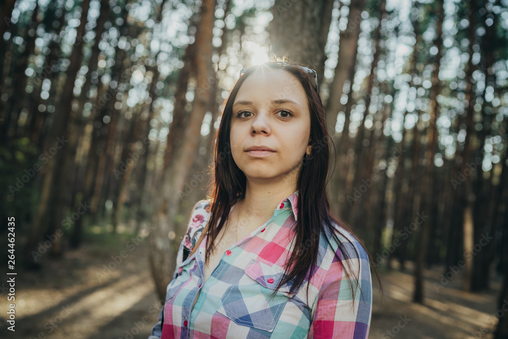 Beautiful woman walking in the woods. Female posing in spring forest, in sunlight Beautiful woman walking in the woods. Female posing in spring forest, in sunlight