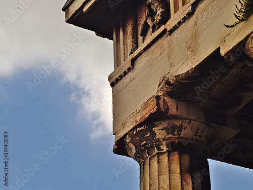 Detail of the temple of Hephaestus in Athens, Greece. Contrast with deep blue sky and clouds. photo