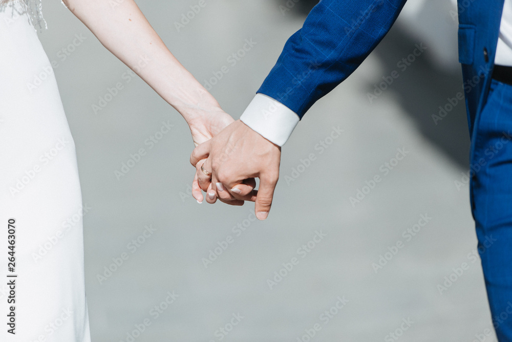 Man and woman hold hands close up Man and woman hold hands close up