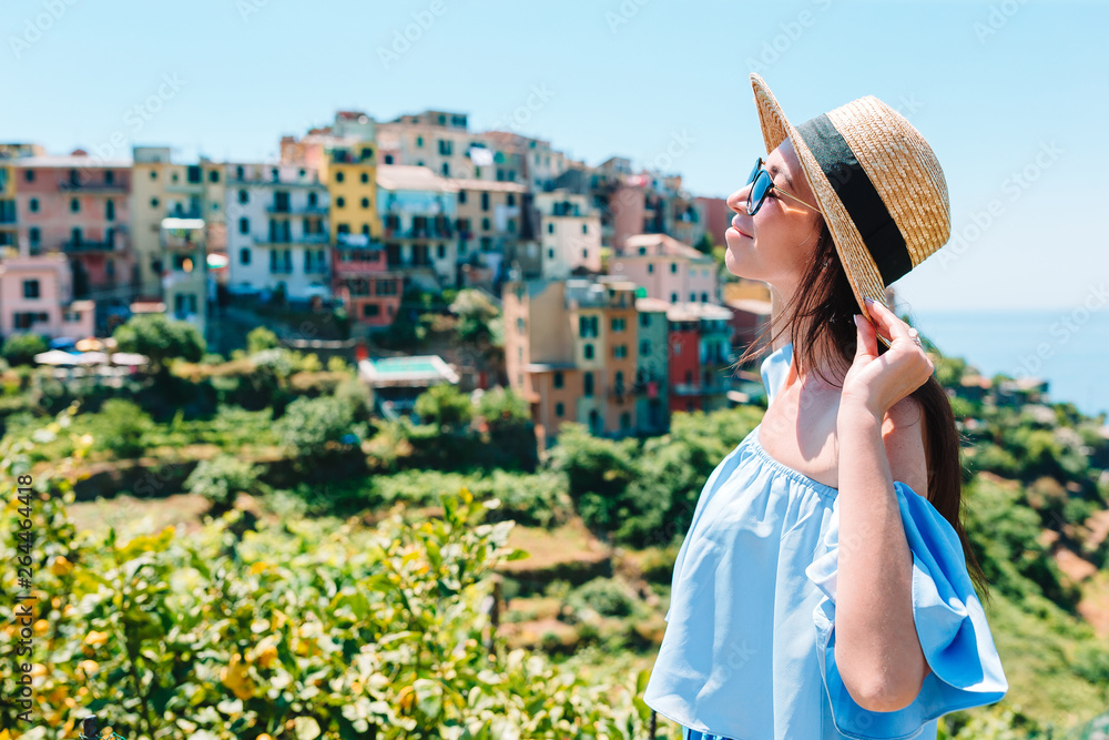Young woman with beautiful view at old village in Cinque Terre, Liguria, Italy. European italian vacation.