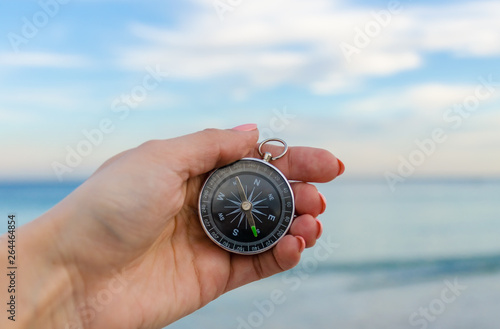 Girl holding a comass on the Odesa sea background photo