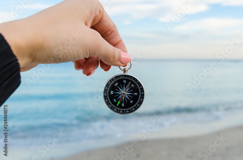 Girl holding a comass on the Odesa sea background photo