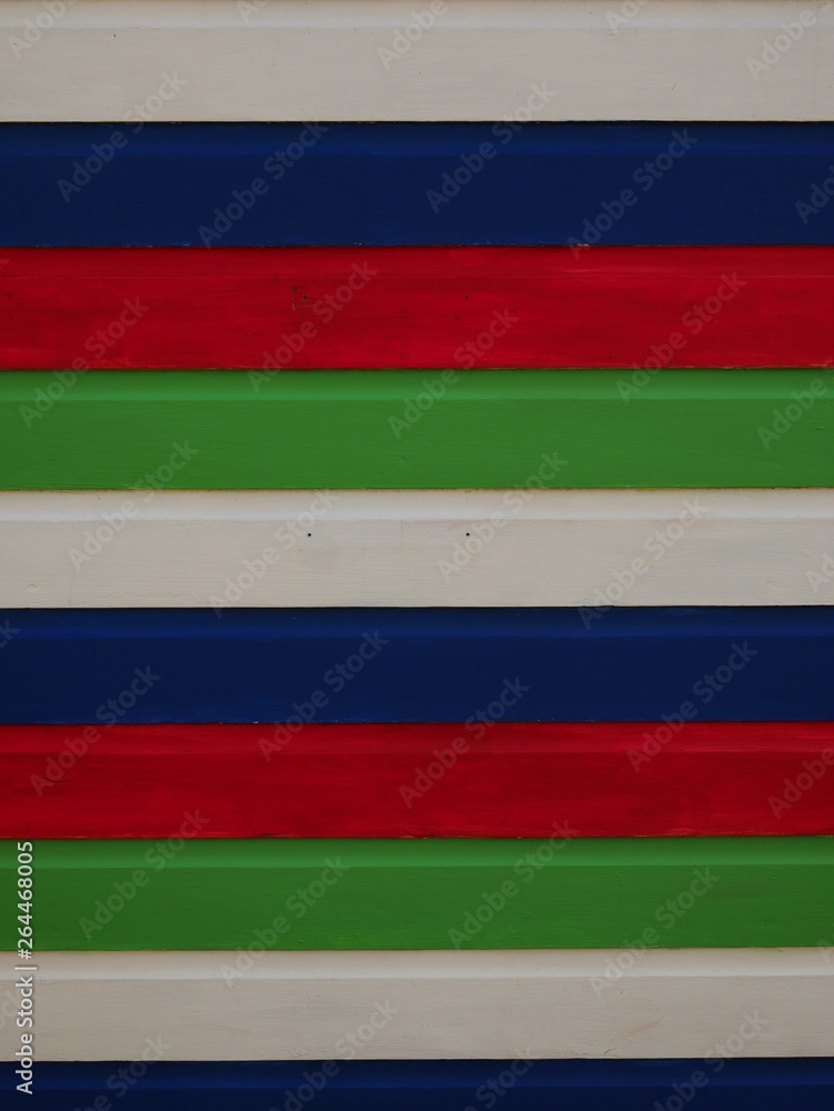 Fototapeta premium Detail of white, blue, red and green striped beach hut