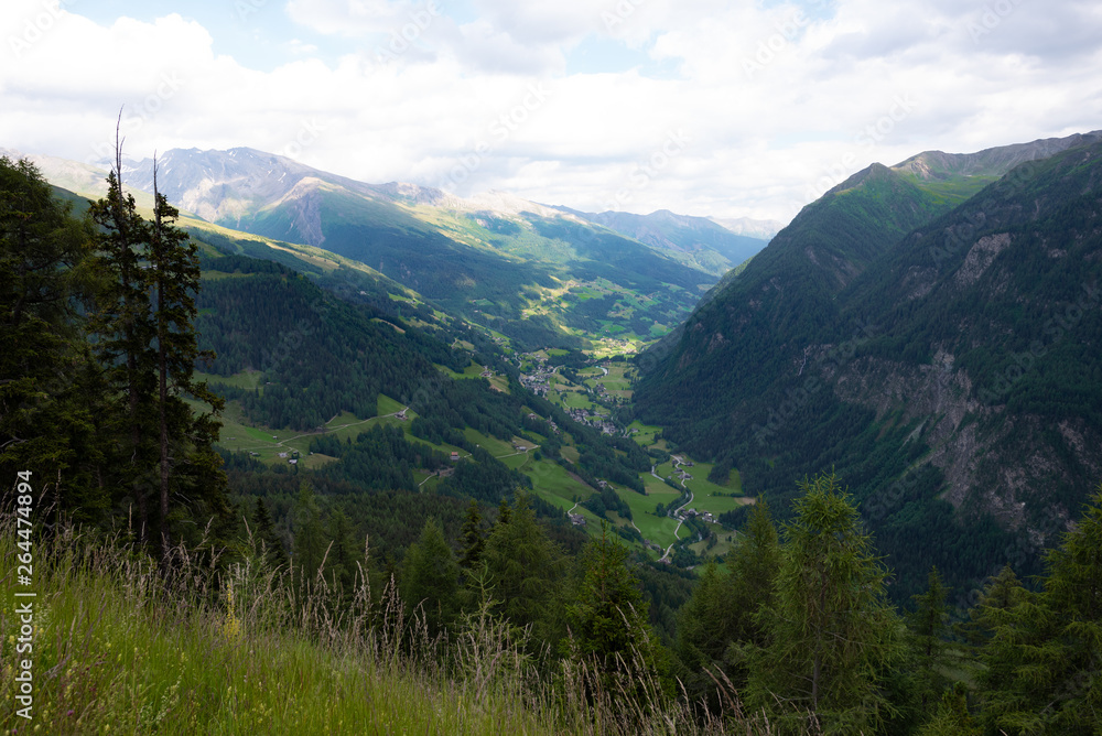 Fototapeta premium Mountains valley small town summer cloudy sky