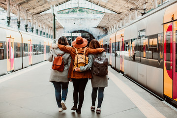 .A group of young friends waiting relaxed and carefree at the station in Porto, Portugal before catching a train. Travel photography. Lifestyle.